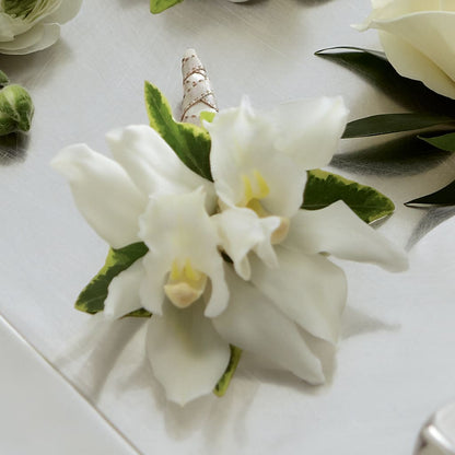 White Mini Cymbidium Boutonniere – BUSSE AND RIECK FLOWERS PLANTS & GIFTS, Kankakee IL